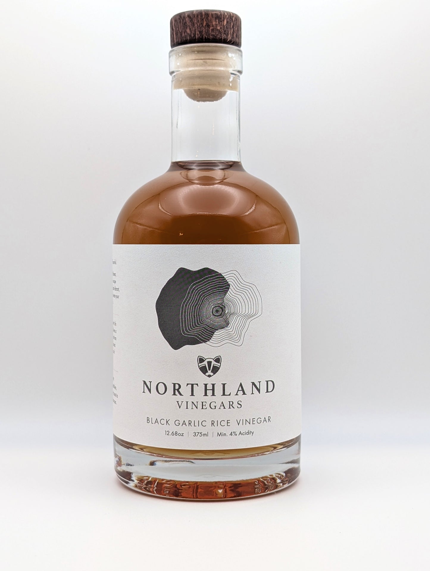 Bottle of Northland Vinegars Black Garlic Rice Vinegar on a white background