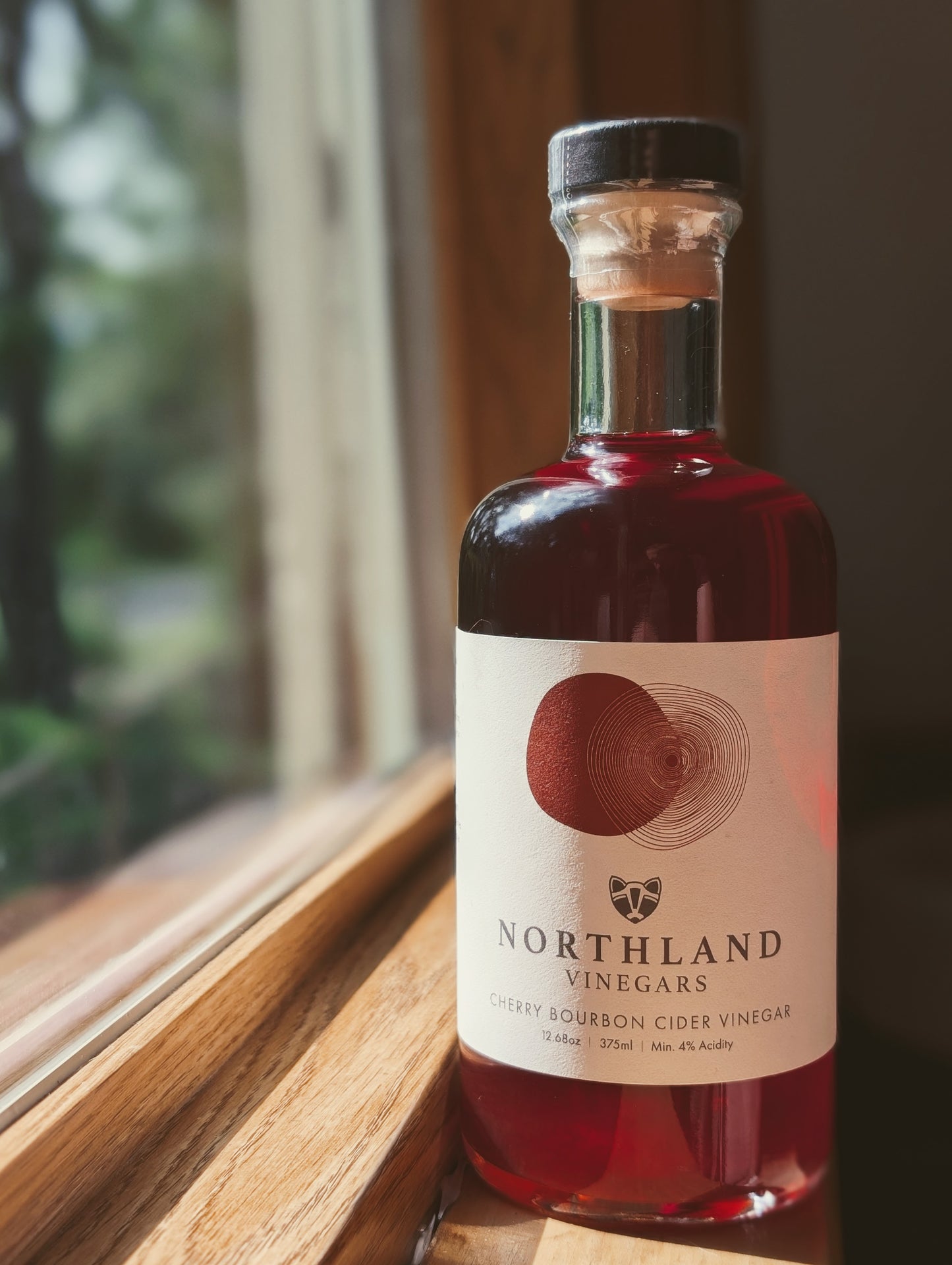 Bottle of Northland Vinegars Cherry Bourbon Cider Vinegar with rich cherry and oaky bourbon notes, handcrafted in Minnesota.