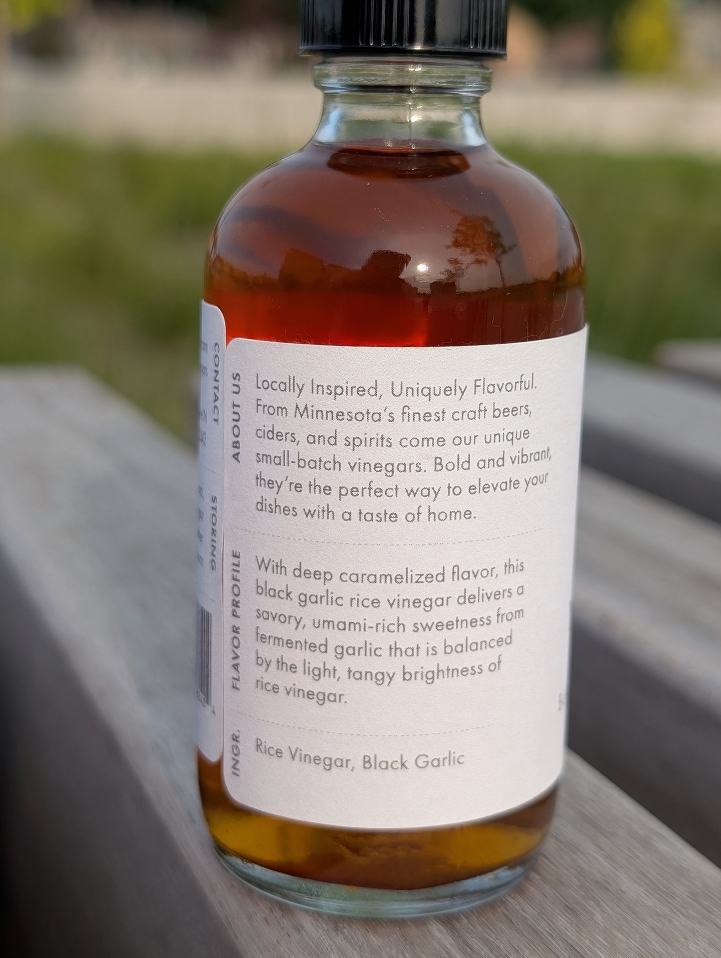 Bottle of rice vinegar with a label on a wooden surface