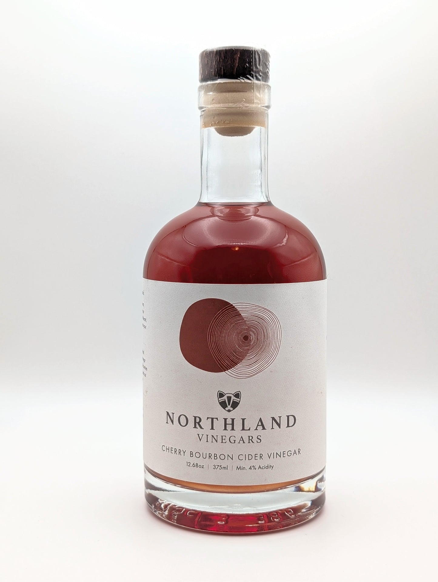Bottle of Northland Vinegars Cherry Bourbon Cider Vinegar on a white background