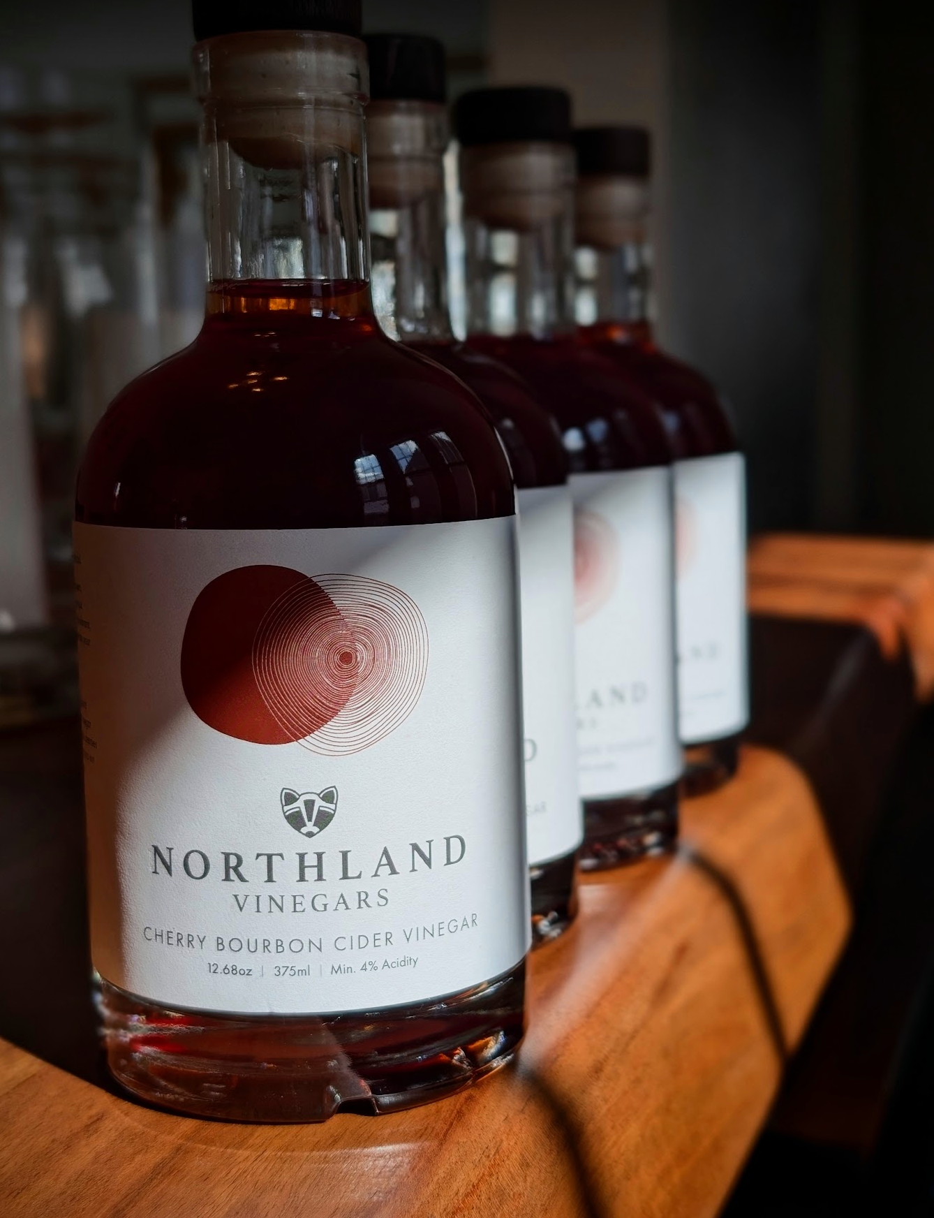 Bottles of Northland Vinegars on a wooden surface with a blurred background