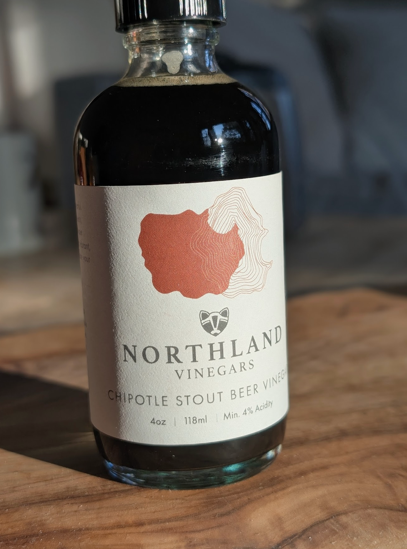 Bottle of Northland Vinegars Chipotle Stout Beer Vinegar on a wooden surface