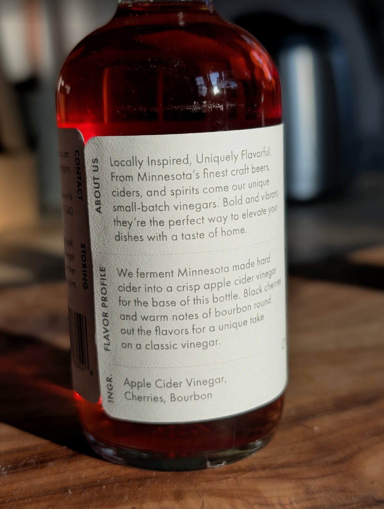 Bottle of vinegar with a label on a wooden surface