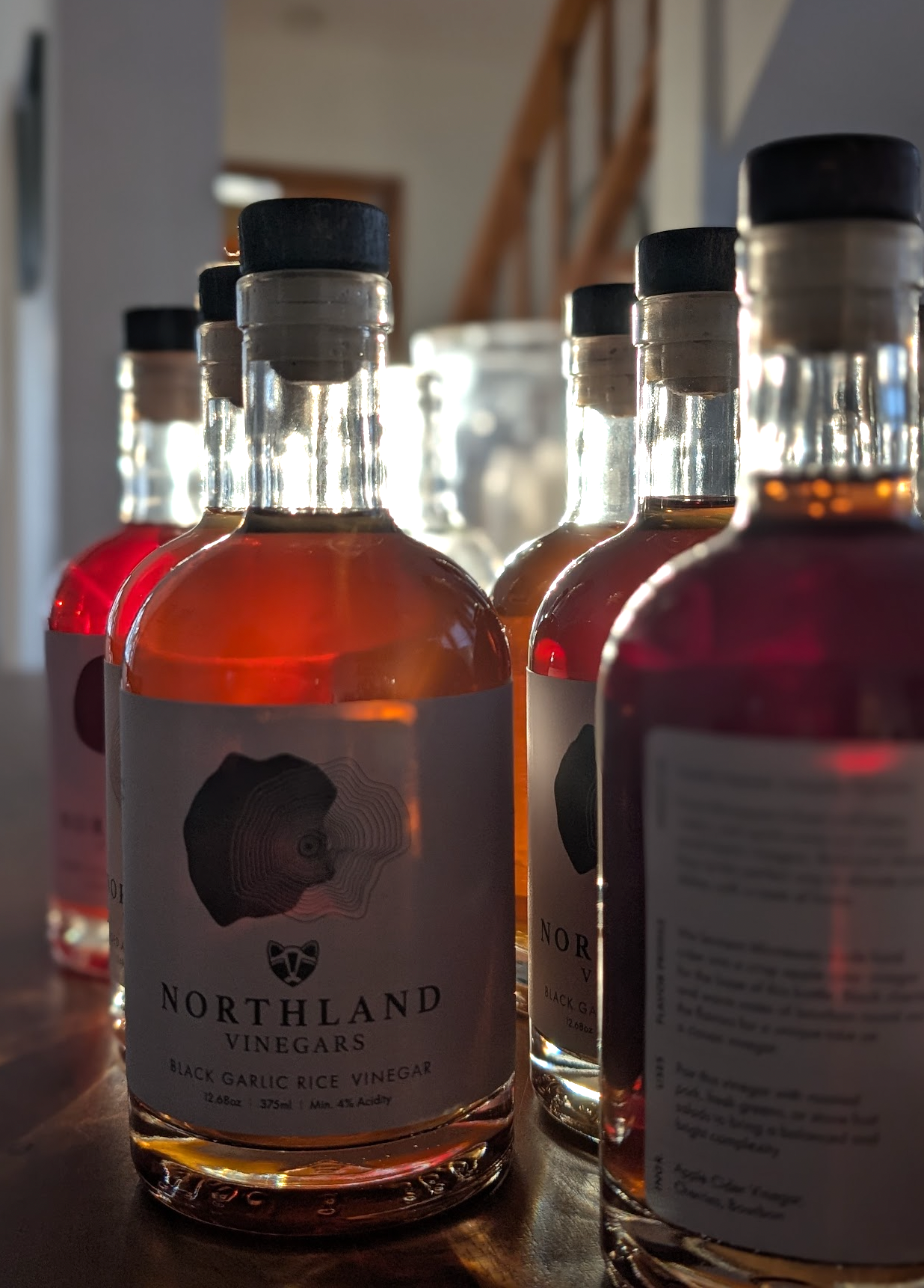 Bottles of Northland Vinegars on a wooden surface with a blurred background