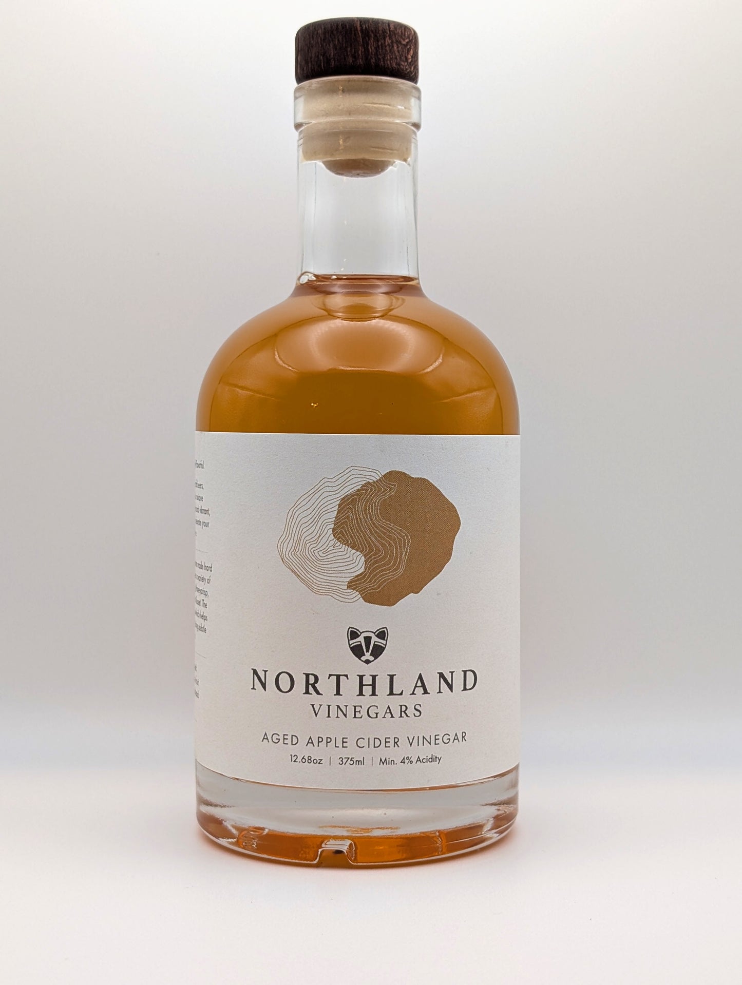 Bottle of Northland Vinegars aged apple cider vinegar on a white background