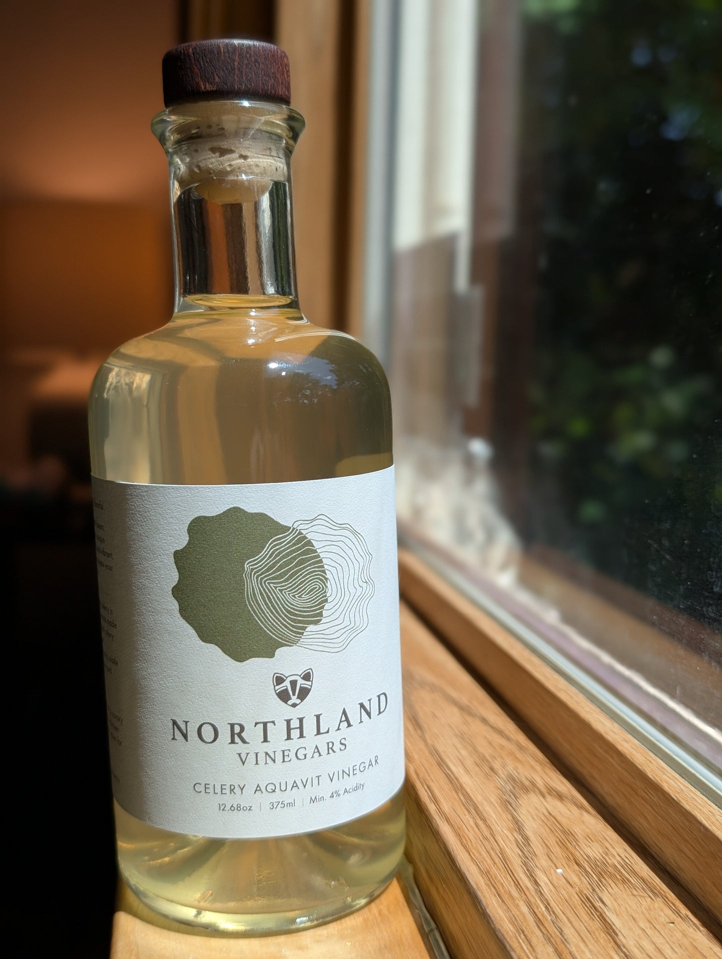 Bottle of Celery Aquavit Vinegar with fresh celery and caraway notes, handcrafted in Minnesota.