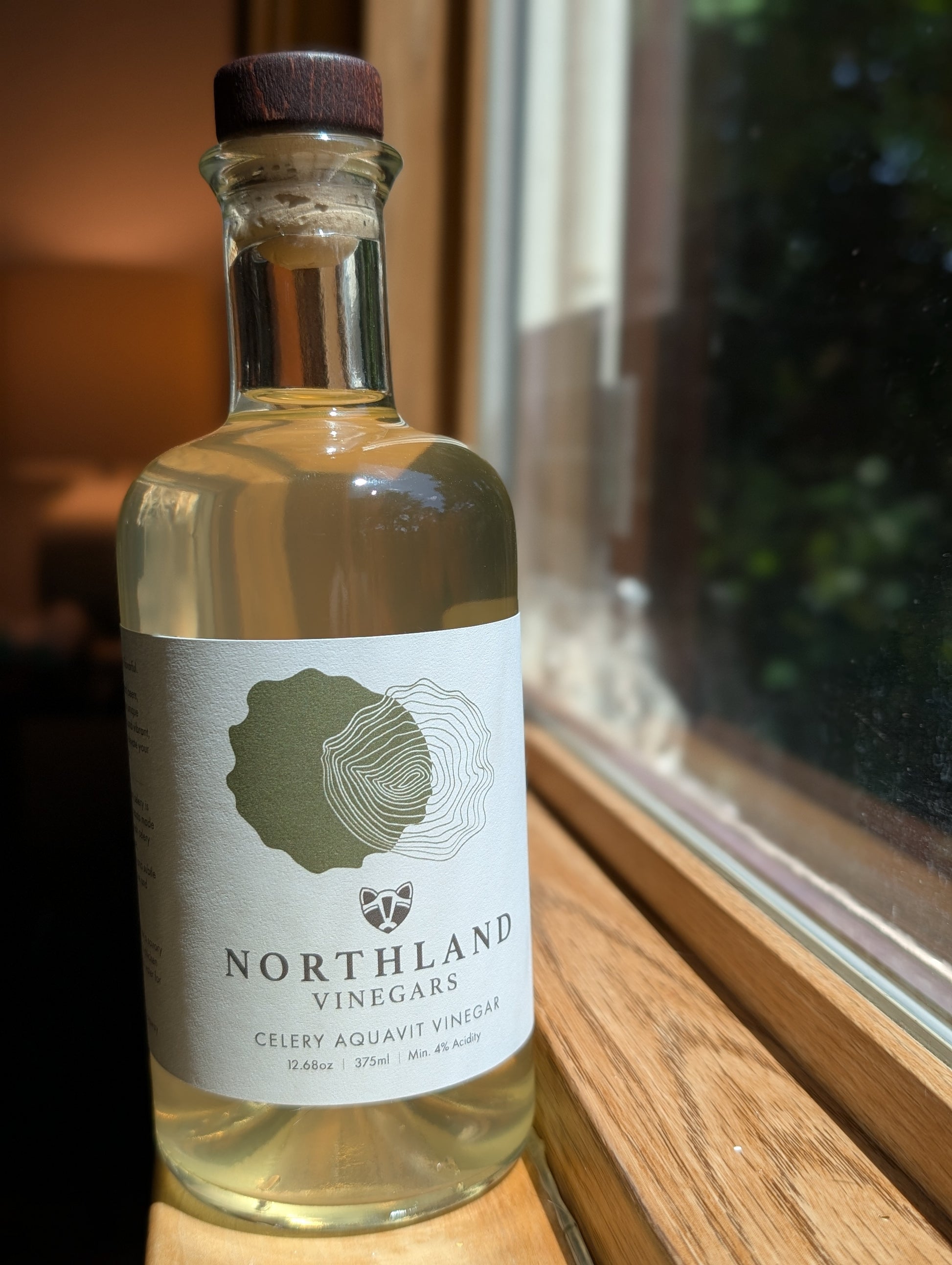 Bottle of Celery Aquavit Vinegar with fresh celery and caraway notes, handcrafted in Minnesota.