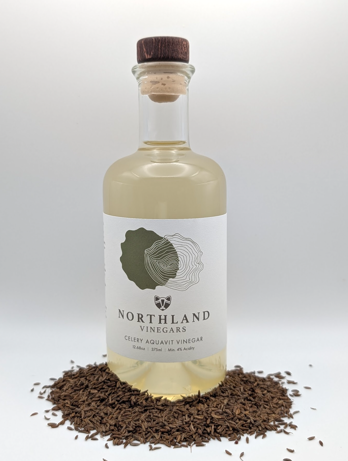 Bottle of Celery Aquavit Vinegar with fresh celery and caraway notes, handcrafted in Minnesota.