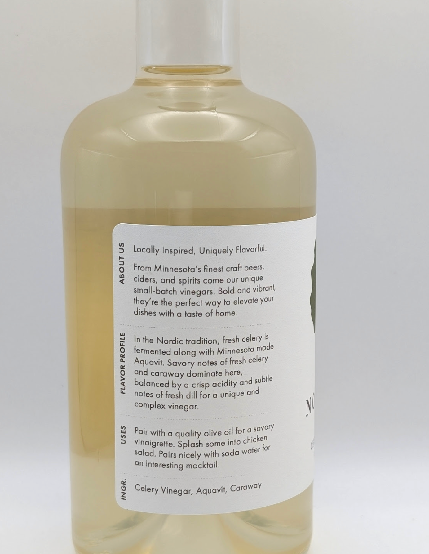 Bottle of Celery Aquavit Vinegar with fresh celery and caraway notes, handcrafted in Minnesota.