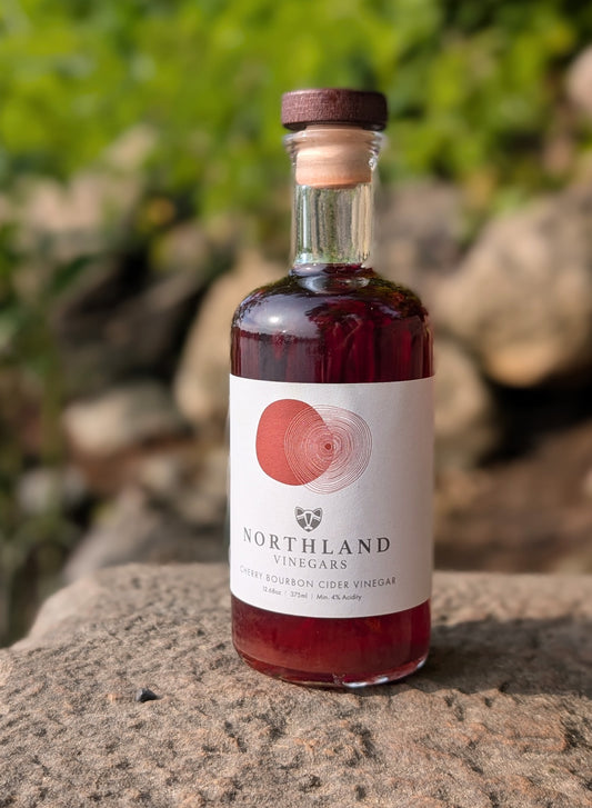 Bottle of Northland Vinegars Cherry Bourbon Cider Vinegar with rich cherry and oaky bourbon notes, handcrafted in Minnesota.